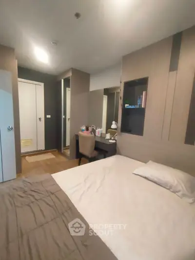 Cozy bedroom with modern decor and built-in storage, perfect for urban living.
