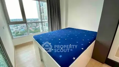 Modern bedroom with large window offering stunning city view and stylish decor.