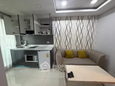 Modern living room with compact kitchen and stylish decor
