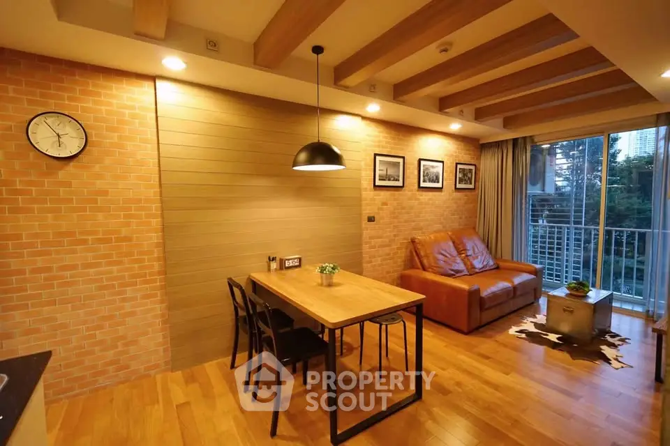 Modern living room with wooden floors, brick walls, and balcony view.