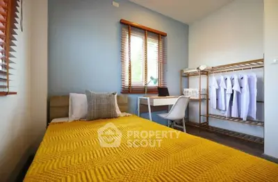 Cozy bedroom with modern decor and ample natural light, perfect for relaxation and productivity.