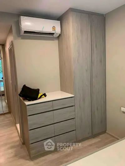 Modern bedroom with sleek wardrobe and air conditioning unit