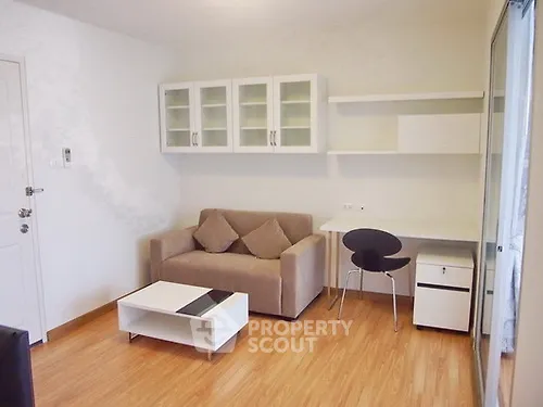 Modern living room with cozy sofa, sleek coffee table, and stylish workspace in bright apartment.