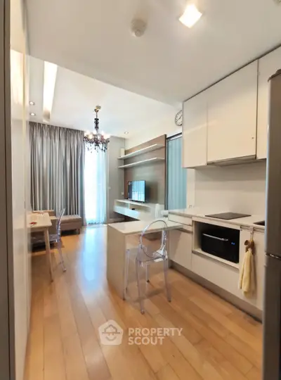 Modern kitchen with open layout and stylish dining area in a bright apartment.