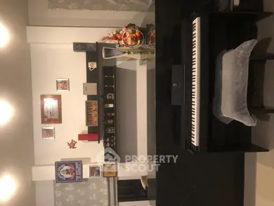 Stylish living room with modern decor and digital piano, perfect for music lovers.