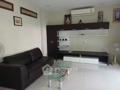 Modern living room with sleek furniture and air conditioning unit