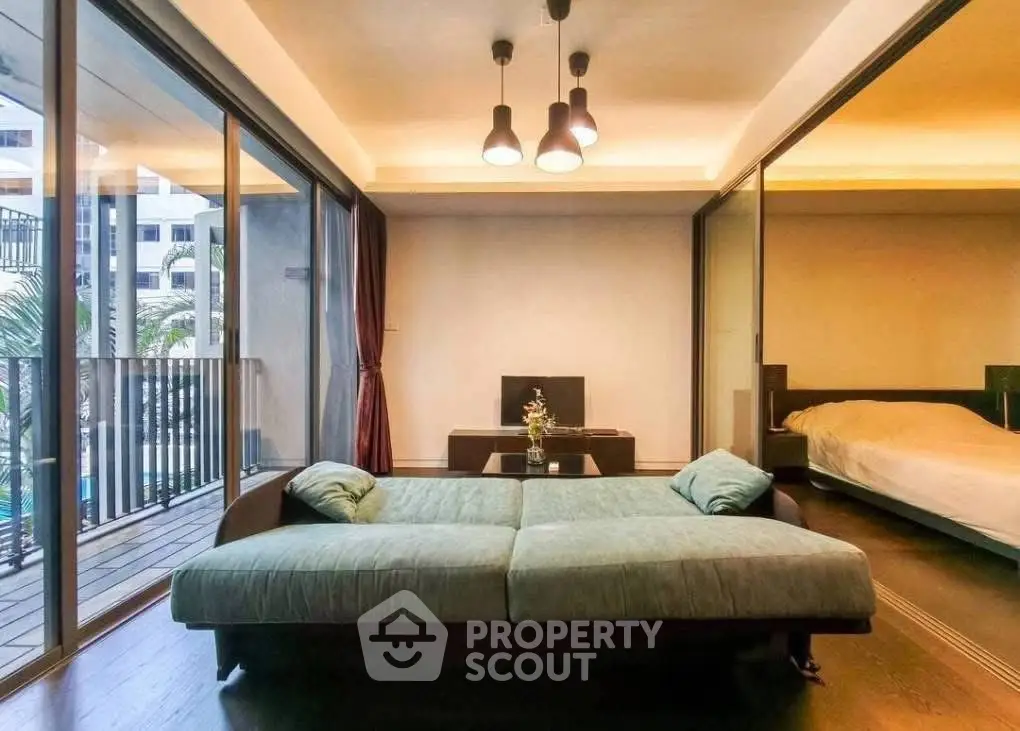 Luxurious living room with modern decor and spacious balcony view