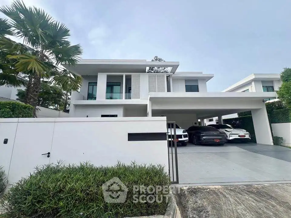 Luxurious modern villa with spacious driveway and sleek architecture in a serene neighborhood.
