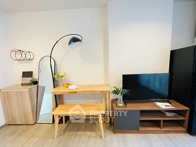 Modern living room with stylish furniture and TV setup, perfect for cozy urban living.