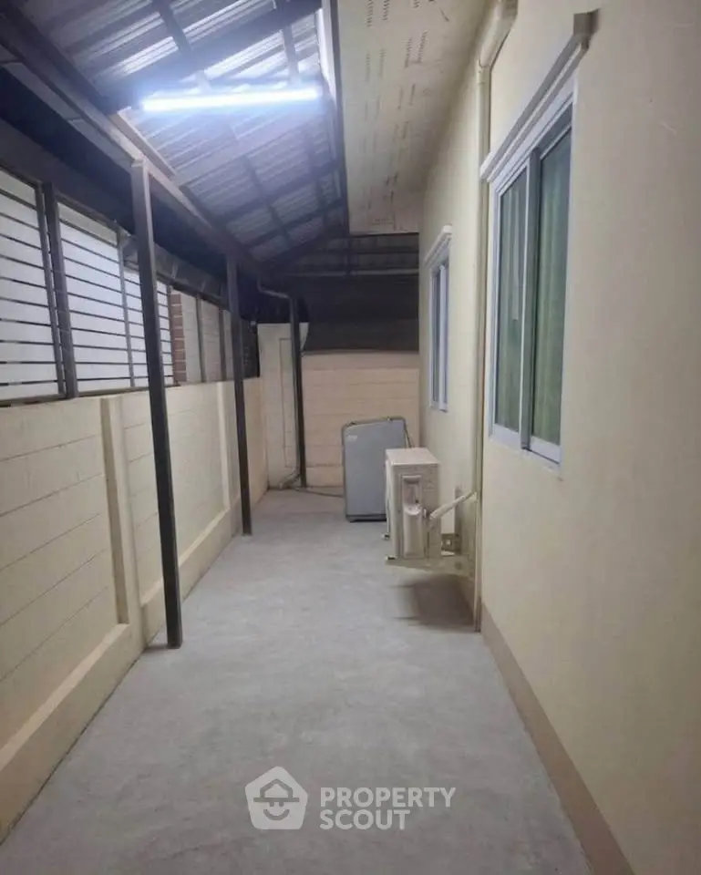 Spacious outdoor corridor with modern design and ample natural light.