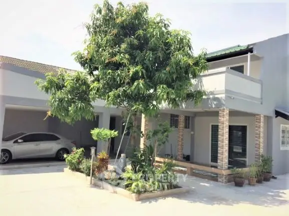 Spacious modern home with large driveway and lush garden, perfect for family living.