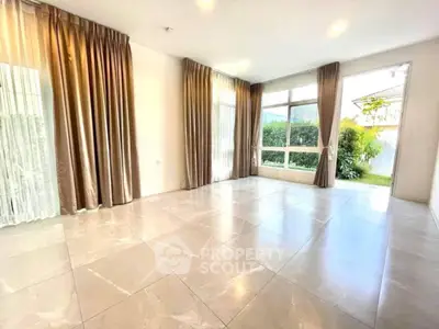 Spacious living room with large windows and garden view