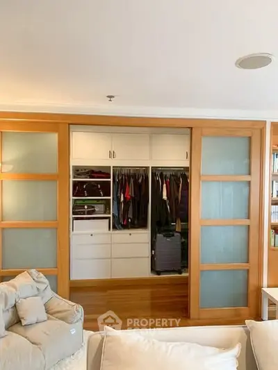 Spacious living room with open closet and sliding doors