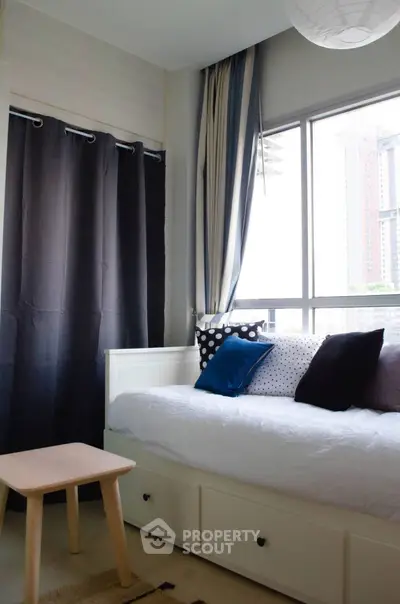 Cozy bedroom with large window and modern decor in urban apartment