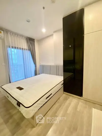 Modern bedroom with sleek design and large window for natural light