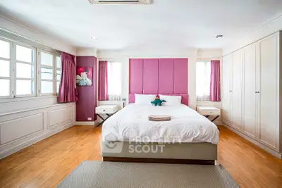 Spacious bedroom with elegant decor and natural light