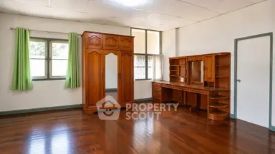 Spacious bedroom with wooden furniture and polished hardwood floors