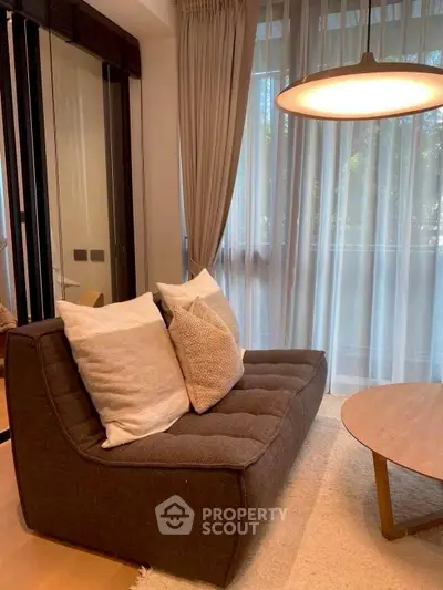 Cozy living room with modern sofa and elegant lighting, perfect for relaxation.
