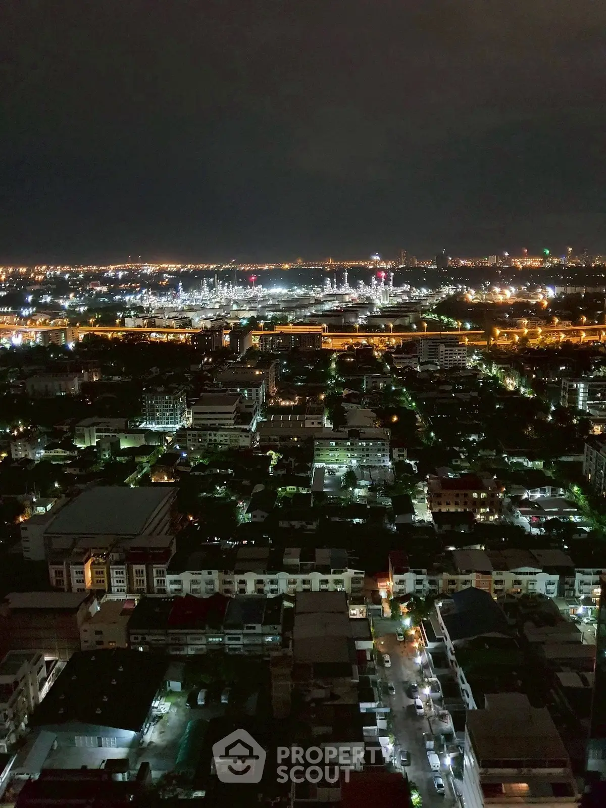 Stunning cityscape night view from high-rise building, showcasing vibrant urban lights and expansive skyline.