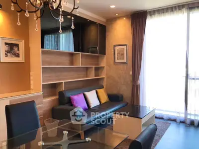 Elegant living room with modern decor, large window, and stylish chandelier in a cozy apartment.