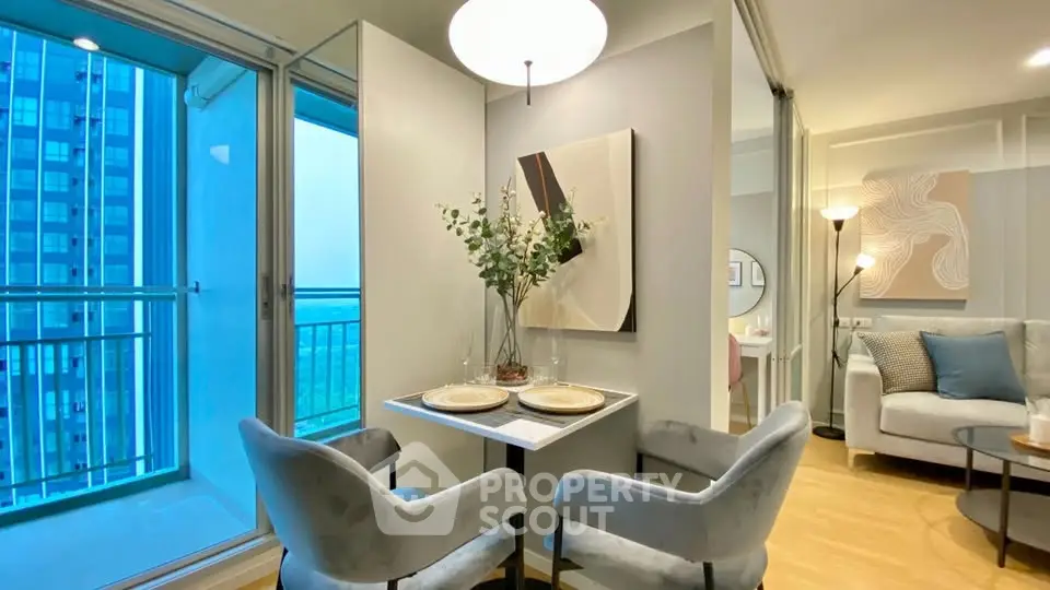 Modern apartment with cozy dining area and elegant living room, featuring stylish decor and a balcony view.