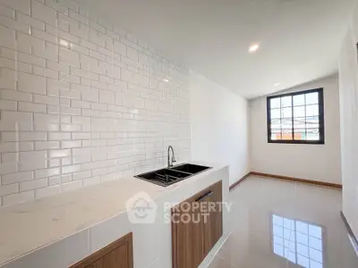 Modern kitchen with sleek white subway tiles and wooden cabinetry