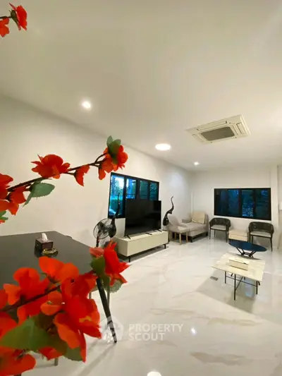 Spacious modern living room with elegant decor and large windows for natural light.