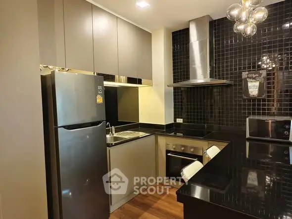 Modern kitchen with sleek black countertops and stainless steel appliances