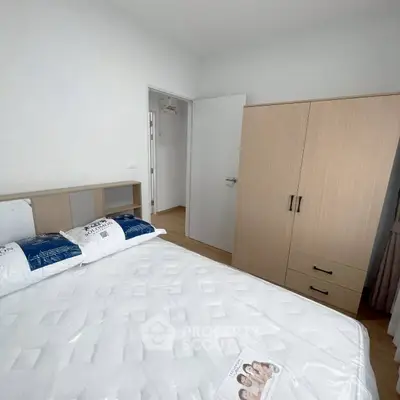 Cozy bedroom with modern wardrobe and comfortable bed in a bright apartment.