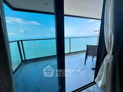 Stunning ocean view from a modern balcony with glass railing and elegant flooring.