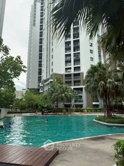 Luxurious high-rise apartment with stunning pool and lush greenery.
