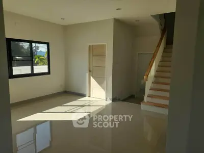 Spacious modern living room with staircase and natural light