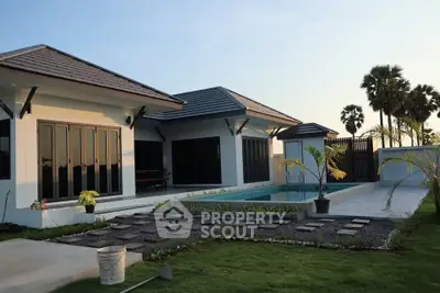 Modern single-story home with pool and landscaped garden, featuring sleek architecture and palm trees.