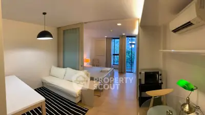 Modern studio apartment with open layout, featuring cozy living area and bedroom, stylish decor, and natural light.