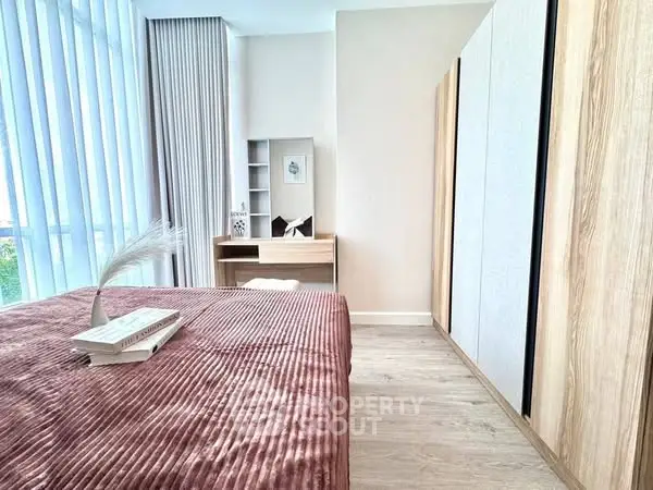 Modern bedroom with stylish decor and ample natural light
