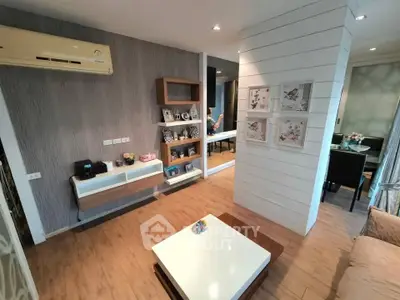 Modern living room with stylish decor and open layout, featuring wooden flooring and contemporary furniture.