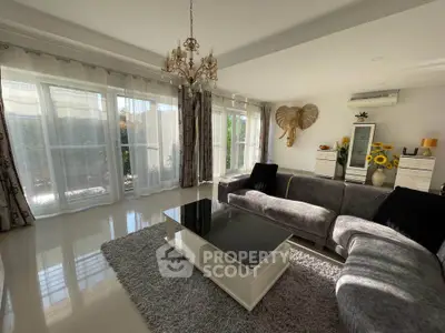 Spacious living room with elegant decor and large windows for natural light