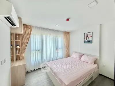 Bright and airy bedroom with modern decor and large window for natural light.