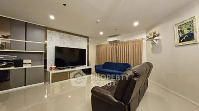Spacious modern living room with elegant decor and large TV