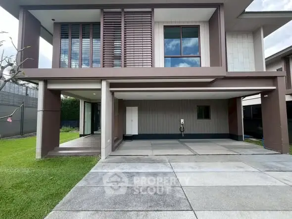 Modern two-story house with spacious driveway and lush green lawn