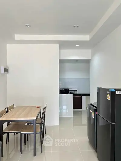 Modern kitchen and dining area with sleek appliances and minimalist design
