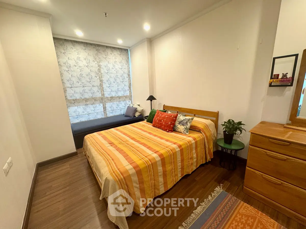 Cozy bedroom with stylish decor and natural light, featuring a comfortable bed and elegant furnishings.