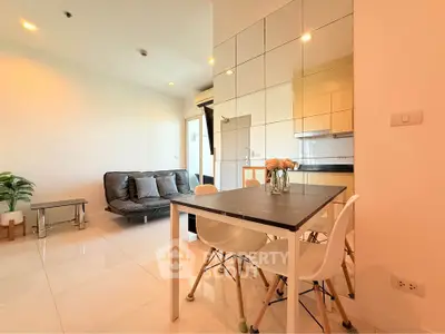 Modern open-plan living room with dining area and stylish decor in a bright apartment.