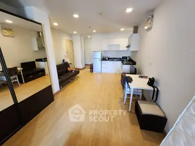 Spacious modern living room with open kitchen and wooden flooring