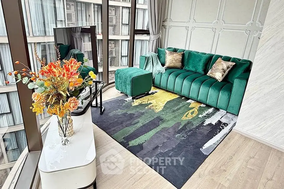 Luxurious living room with modern green sofa and panoramic windows in high-rise apartment.