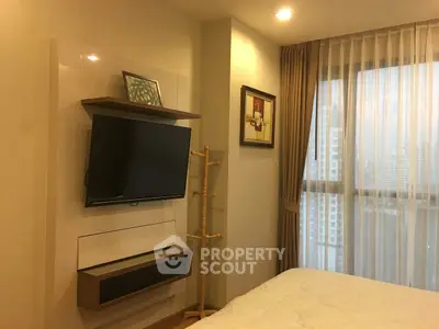 Modern bedroom with wall-mounted TV and large window view