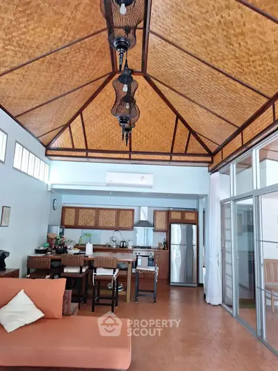 Stunning open-layout kitchen with high bamboo ceiling and modern appliances