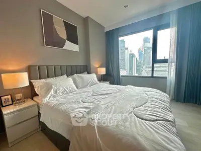 Luxurious bedroom with city view, modern decor, and ample natural light in high-rise apartment.