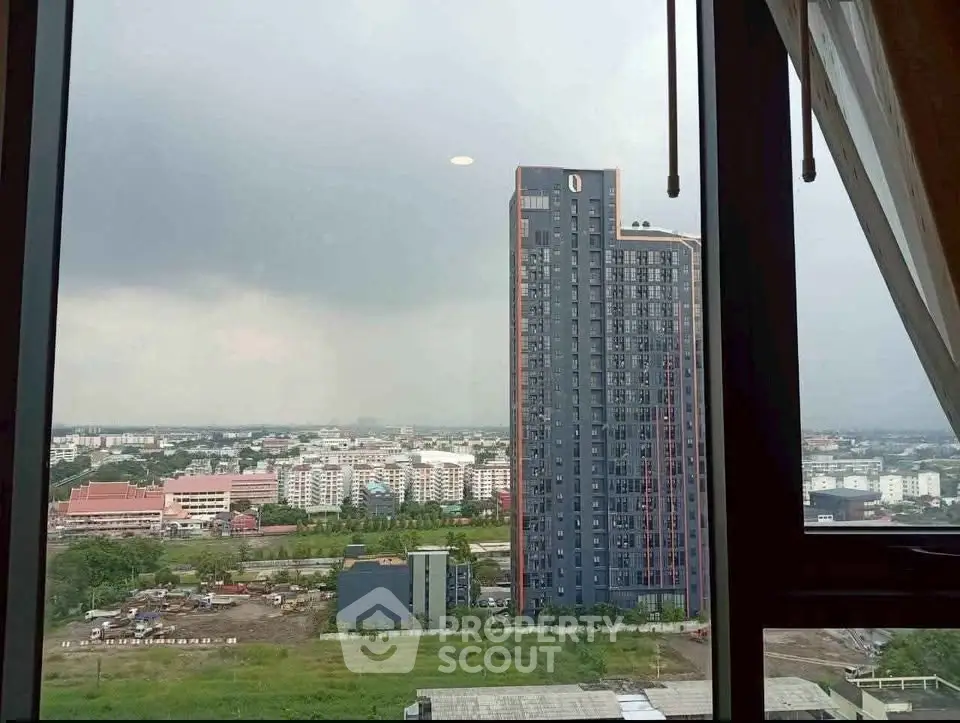 Stunning cityscape view from high-rise apartment window, showcasing modern architecture and expansive urban landscape.