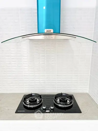 Modern kitchen with sleek gas stove and stylish glass range hood